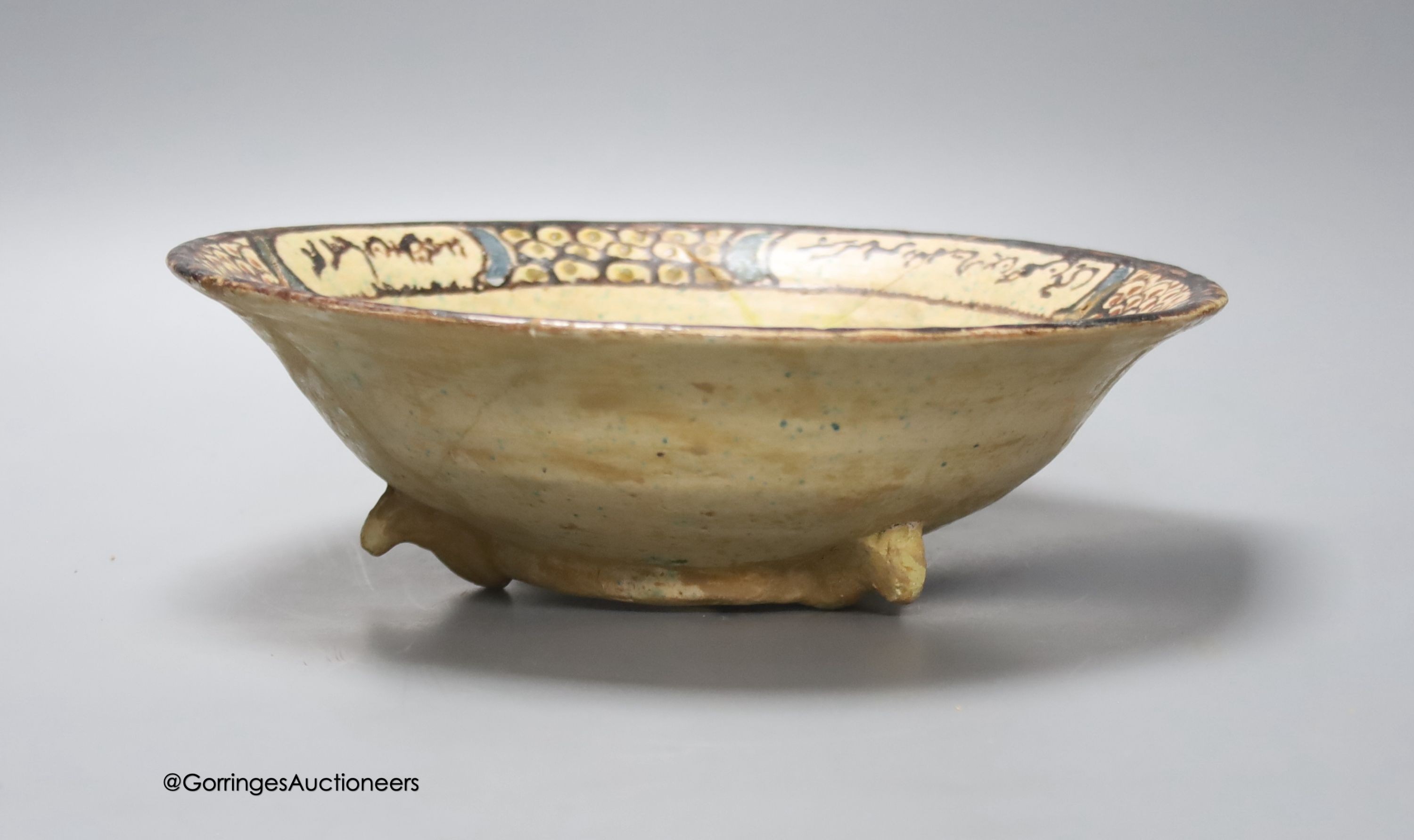 An Islamic bowl with central figure and scripted border, diameter 26cm (a.f.)